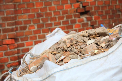 A skip being loaded with construction waste